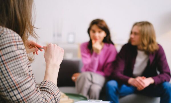 A couple in therapy, guided by a professional therapist in a calm setting. - Photo by SHVETS production on Pexels